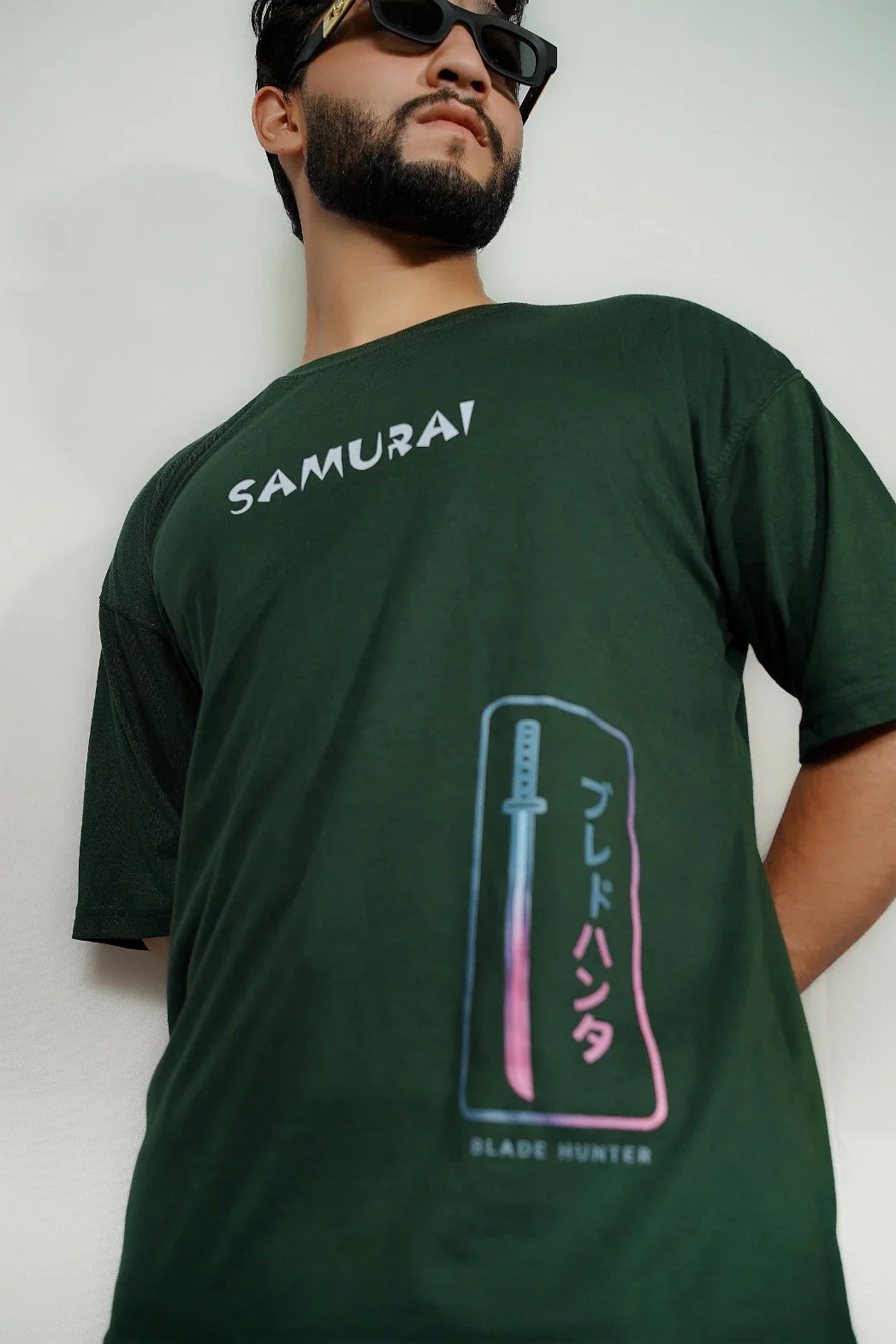 Close-up of dark green Blade Hunter oversized t-shirt front chest samurai katana graphic and SAMURAI text