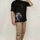 Model wearing black Falcon oversized drop-shoulder t-shirt with minimalist front insignia